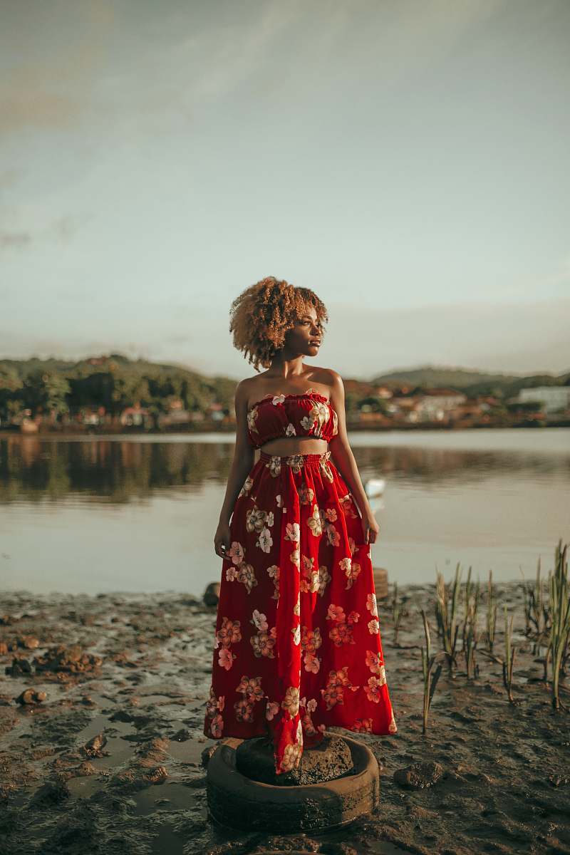 apparel woman wearing red and white floral sleeveless pleated maxi dress clothing