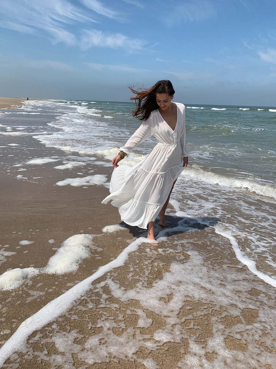 apparel woman wearing white maxi dress at the beach clothing