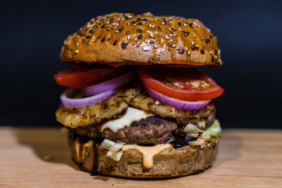 pineapple baked burger on brown surface burger