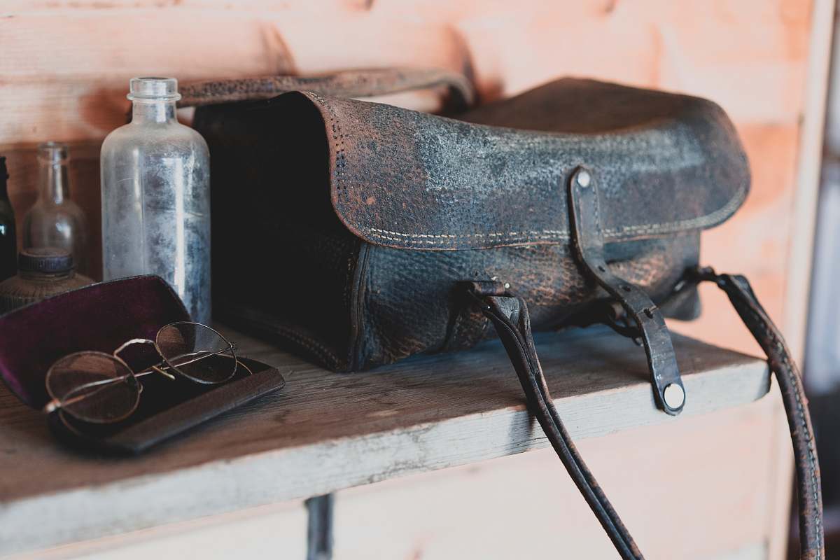 grey black leather bag close-up photography table