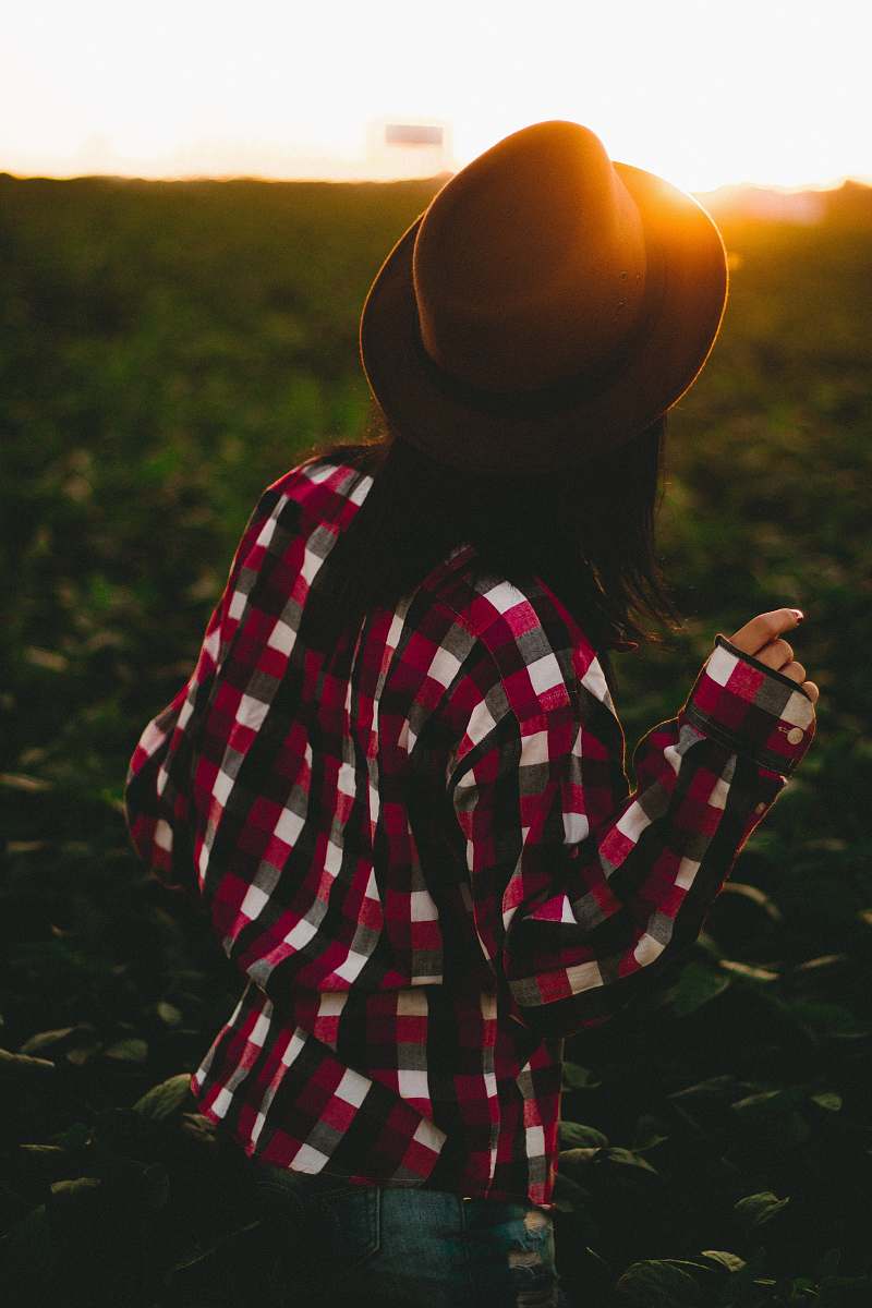 apparel woman wearing hat and checked shirt on green grass clothing