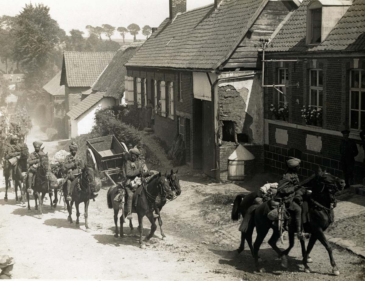 animal people riding horse beside houses grayscale photography mammal