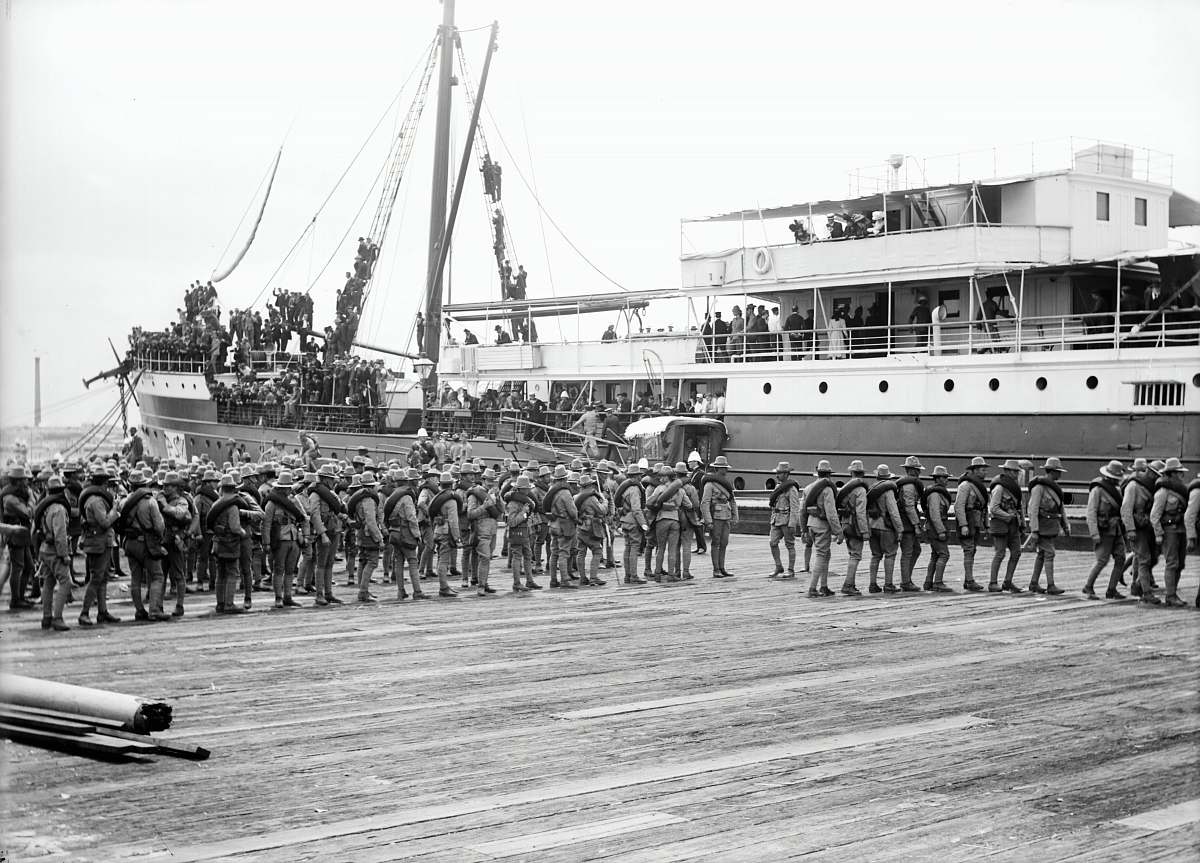 person grayscale photography of soldier marching beside passenger ship black-and-white