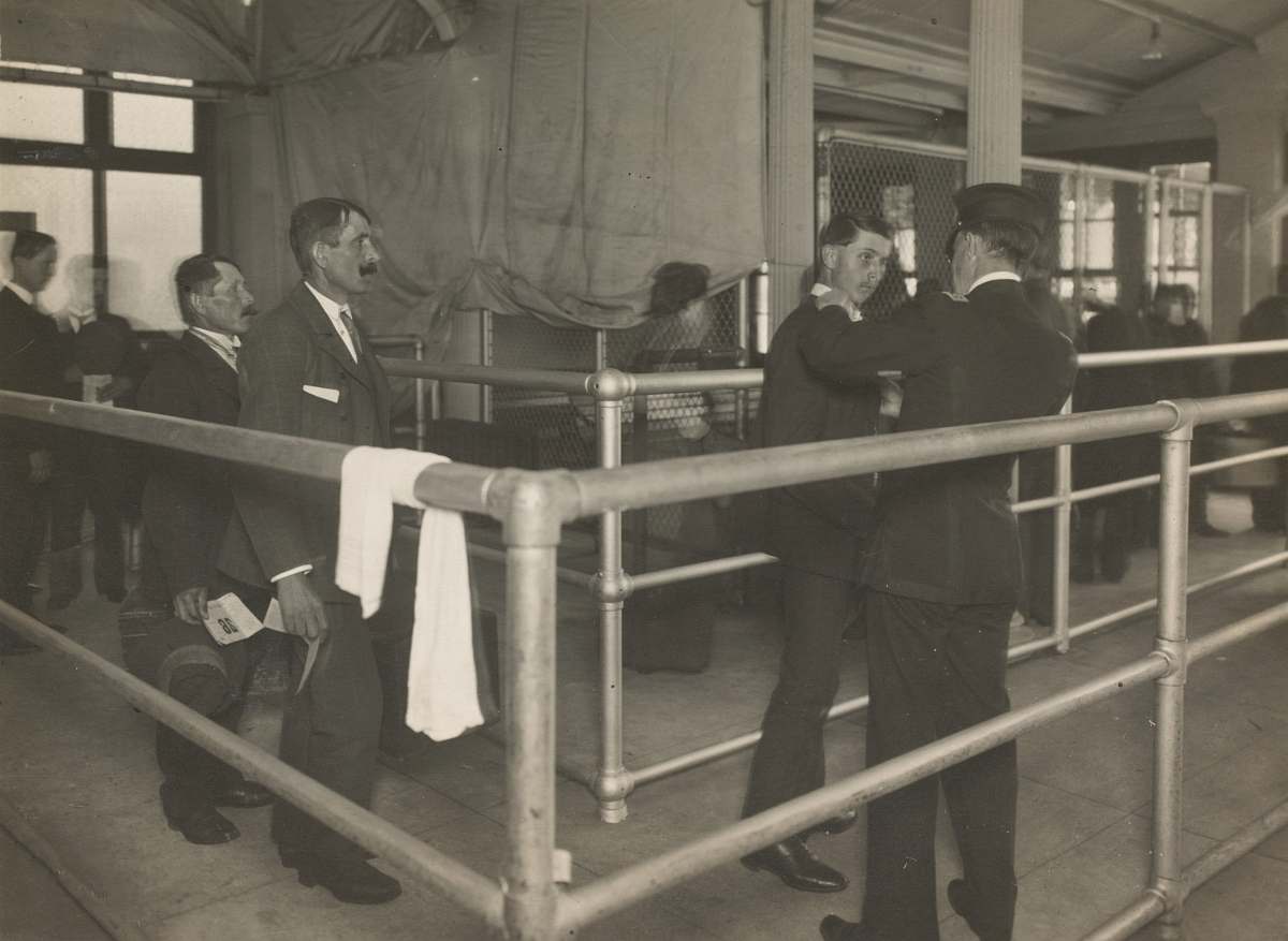 person greyscale photo of men ellis island