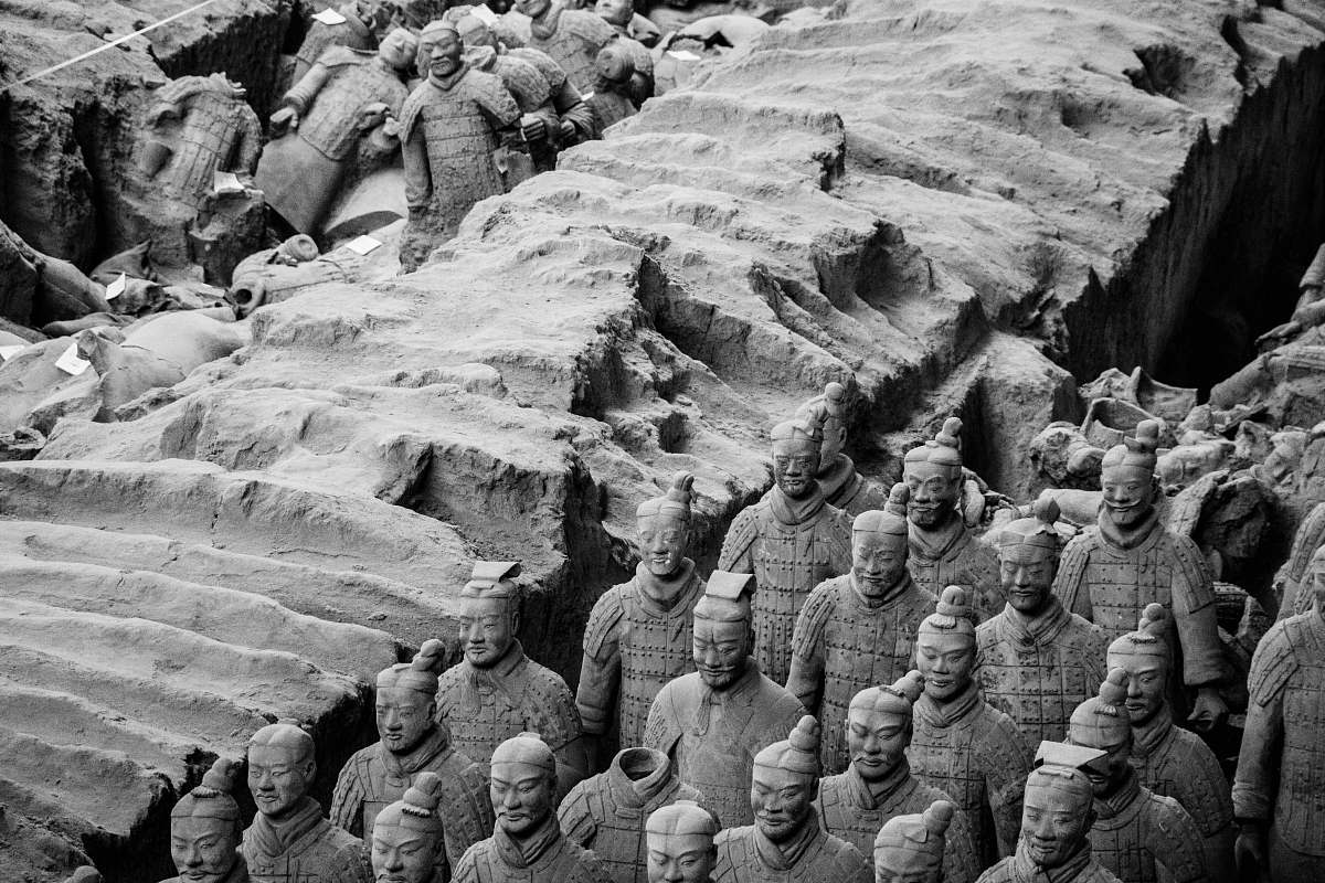 black-and-white human statues soil