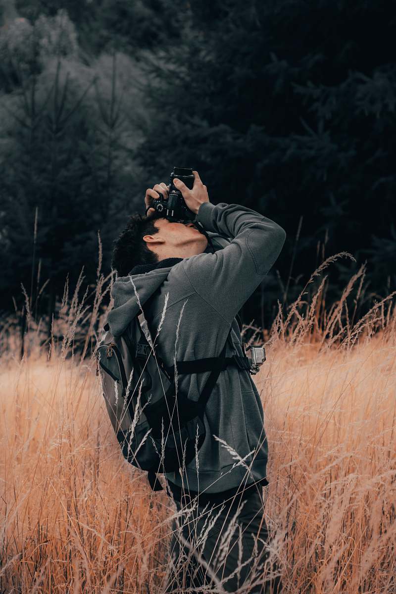 person man taking photo using DSLR camera outdoor photographer