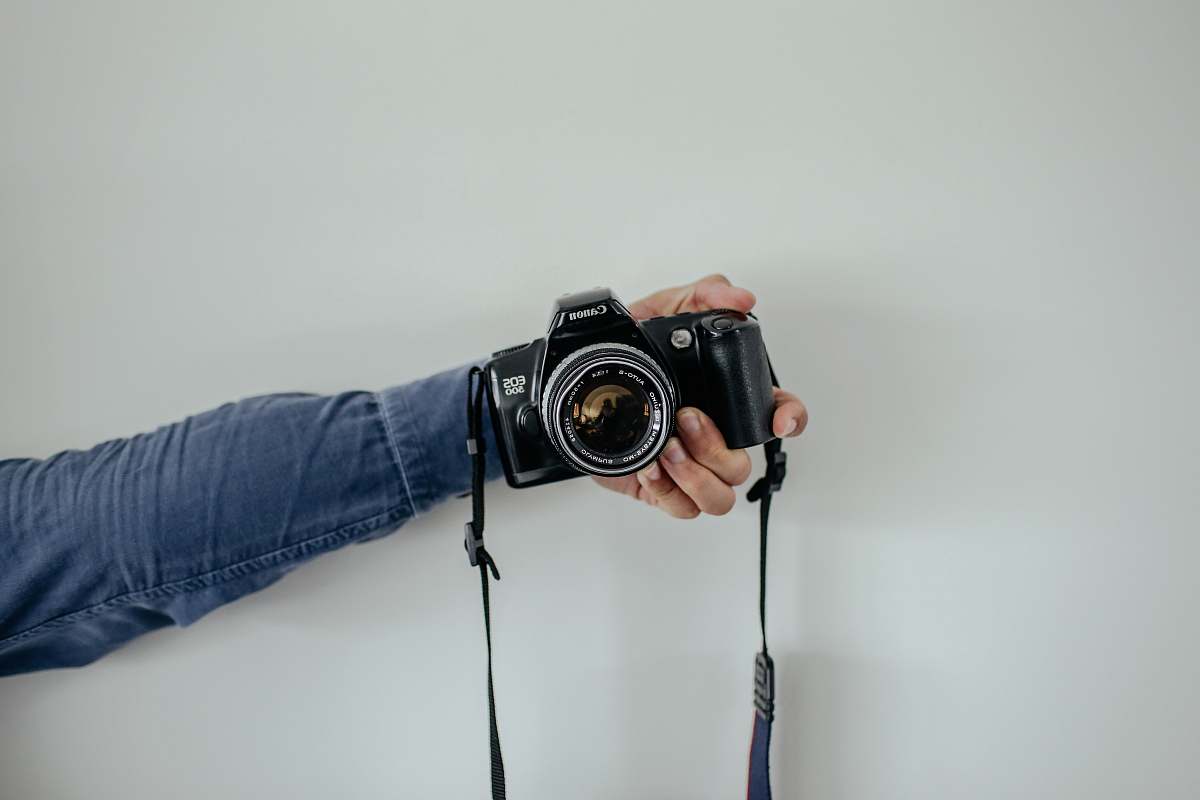 person person holding black camera camera