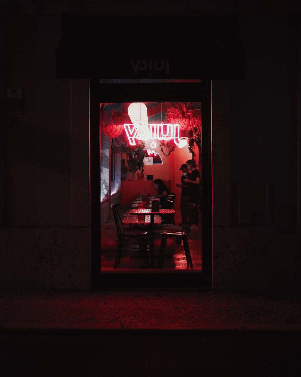 person two people near woman sitting at the table inside building night