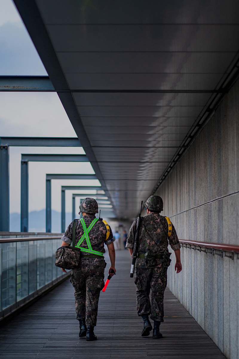 person two soldier men walking on pathway military