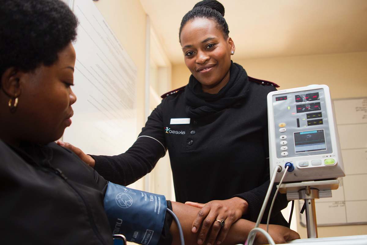 person woman having blood pressure monitor hospital