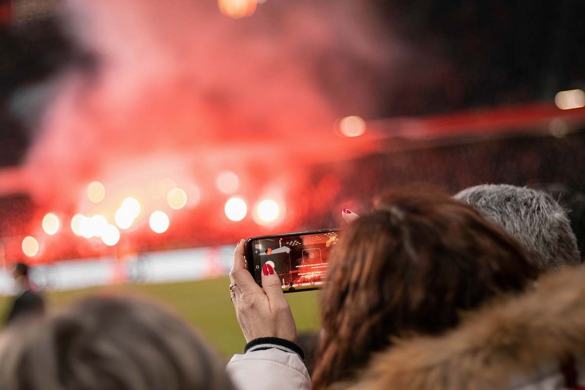 person woman holding phone camera