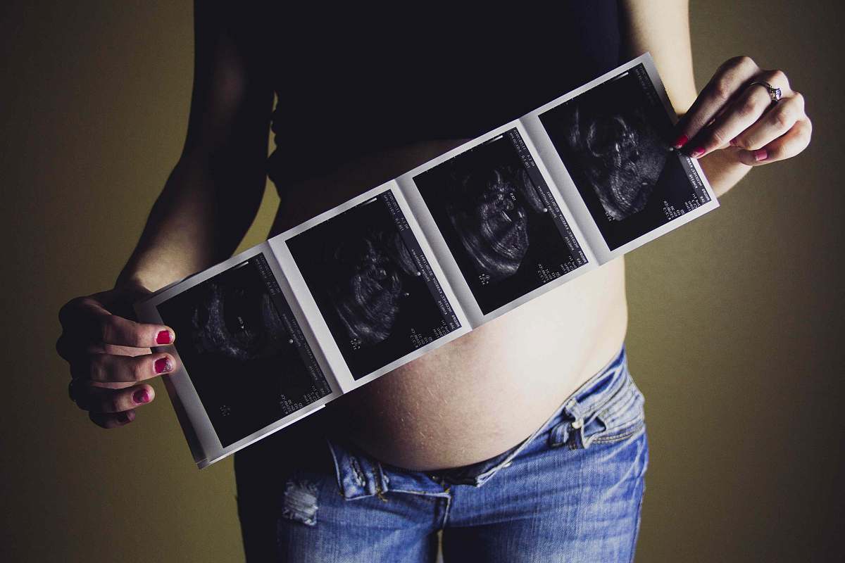 apparel woman holding ultrasound results clothing