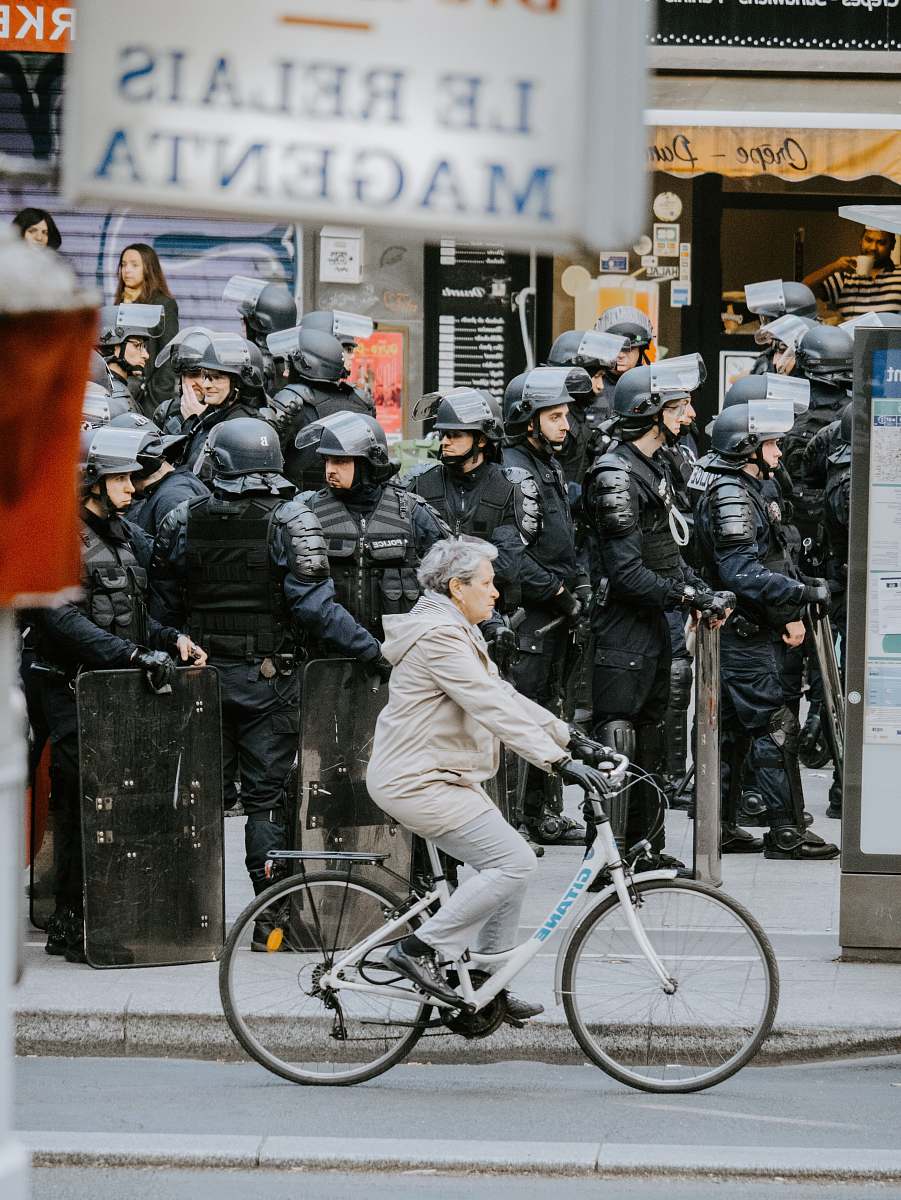wheel woman biking near people on sidewalk bicycle