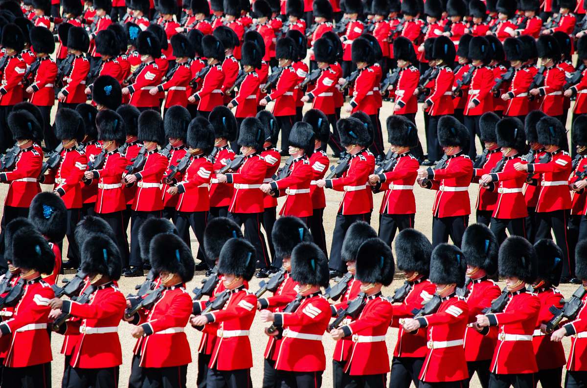 army men in red uniform playing instrument marching