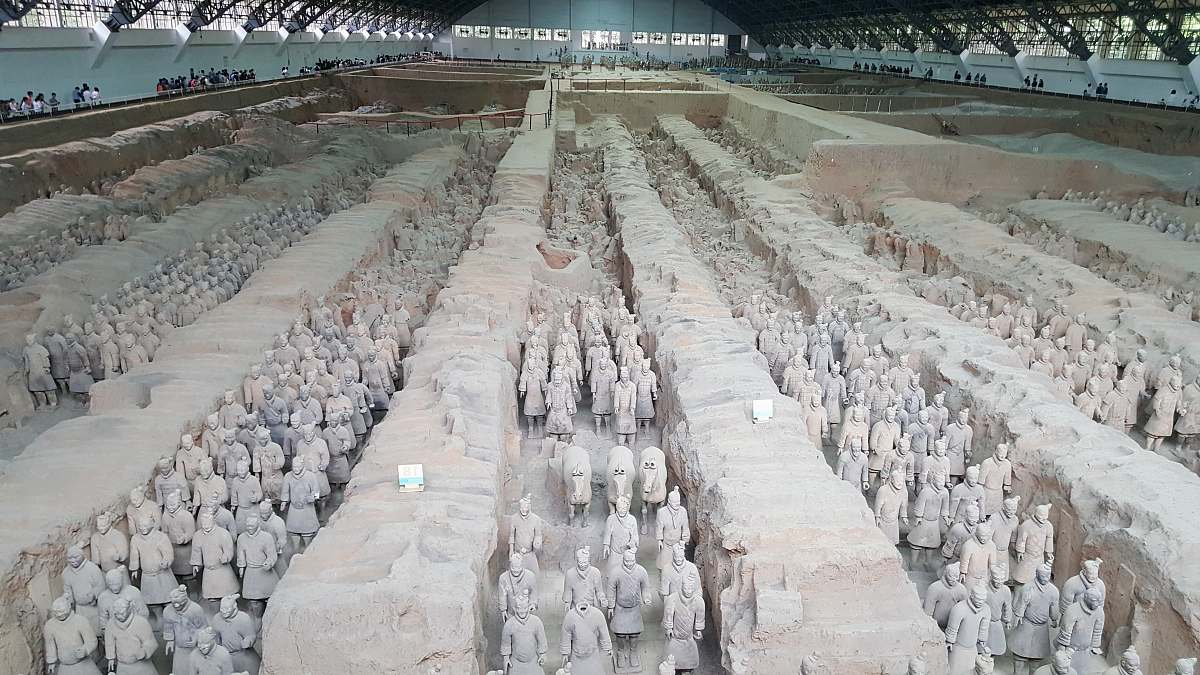 grey terracotta soldiers inside warehouse military uniform