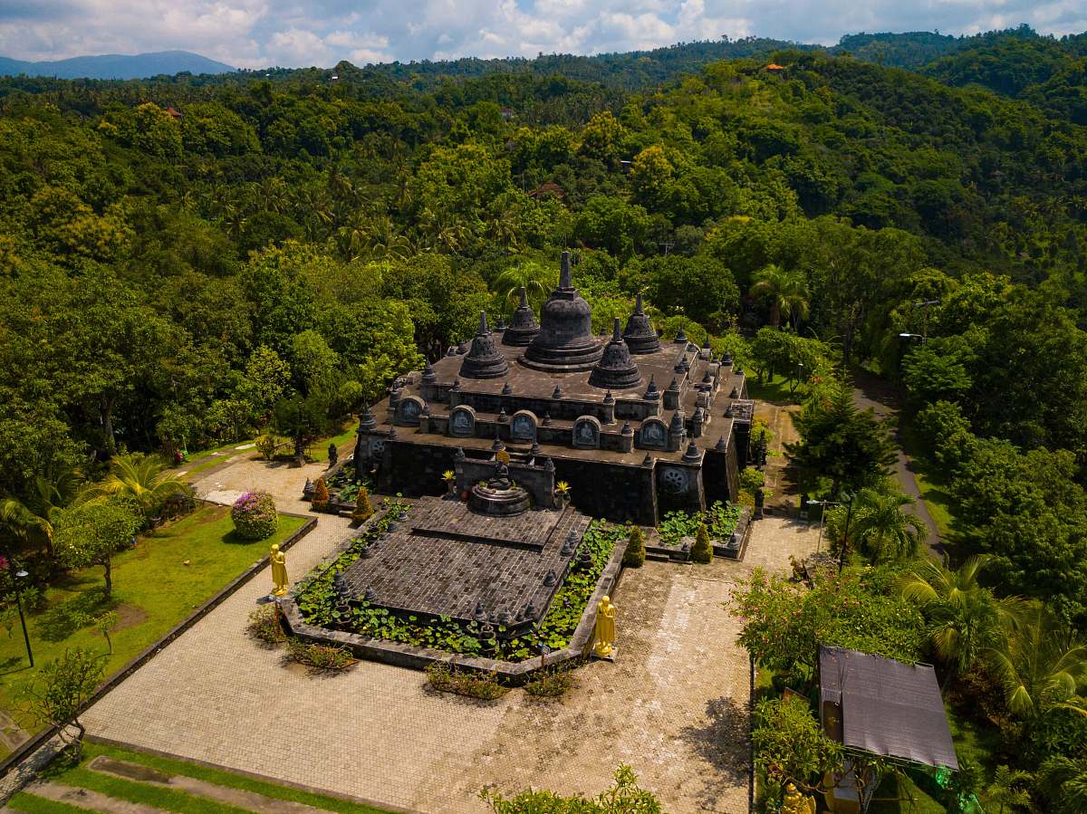 outdoors aerial photography of gray and brown concrete building surrounded by green trees scenery