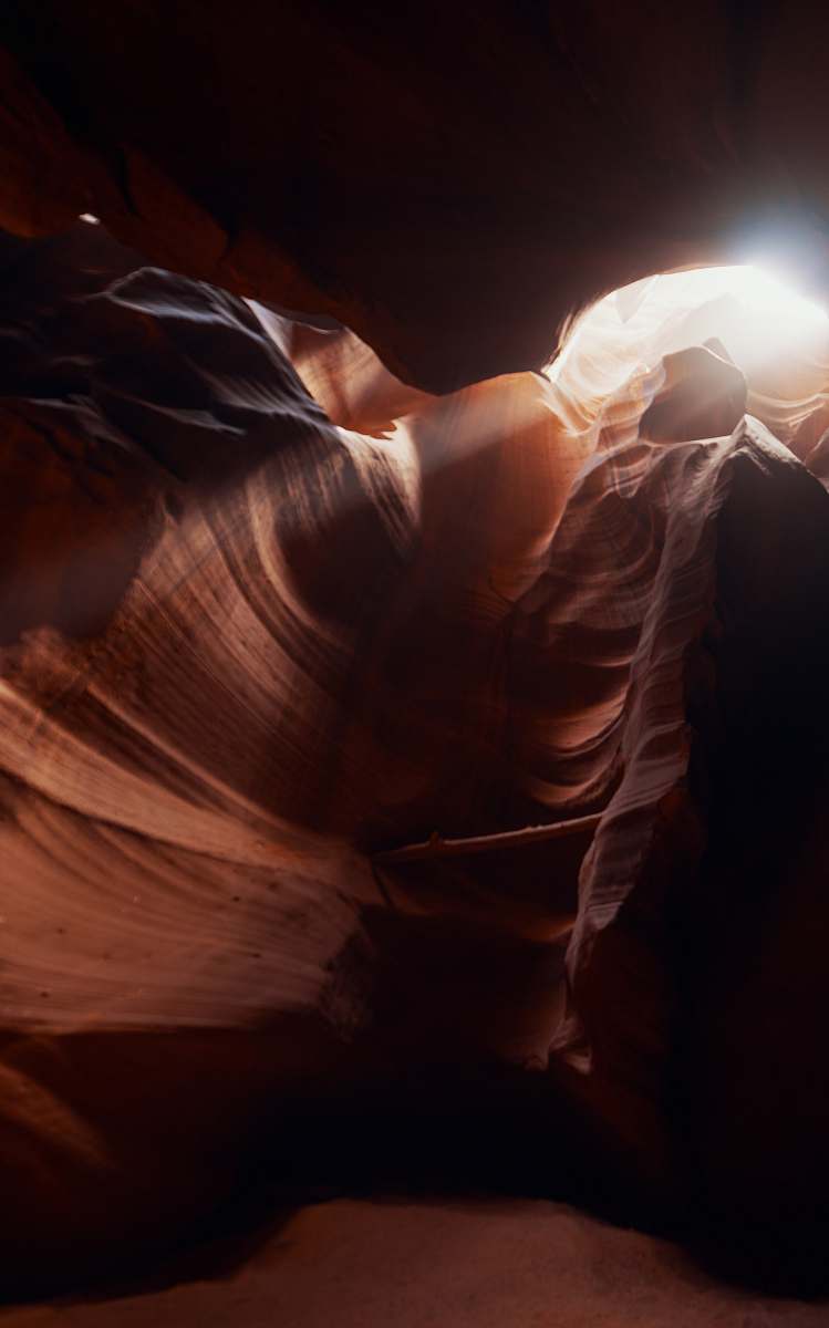 outdoors sun rays coming through cave view mountain