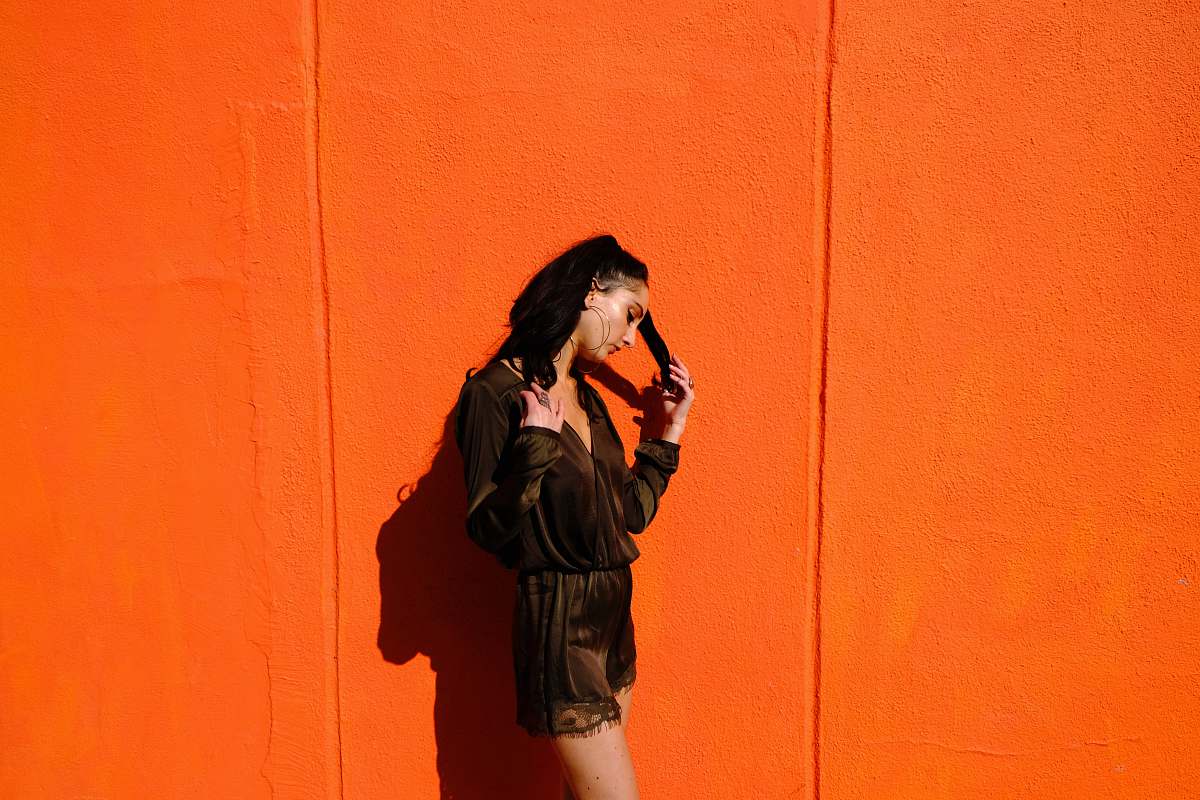 person woman near orange wall human