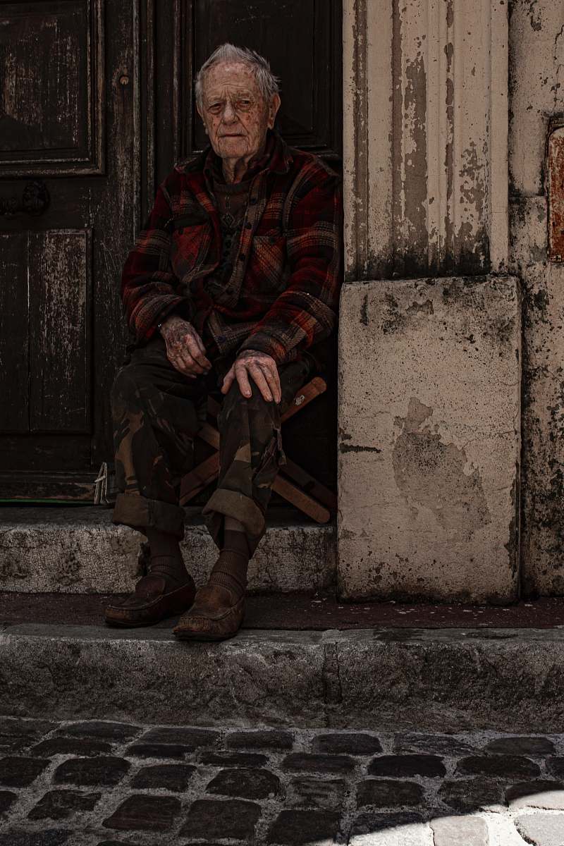 human man sitting on folding chair beside door military
