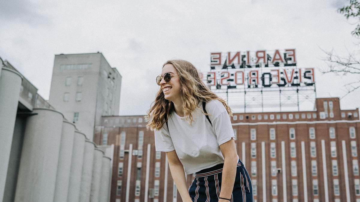 people smiling woman standing near the building human