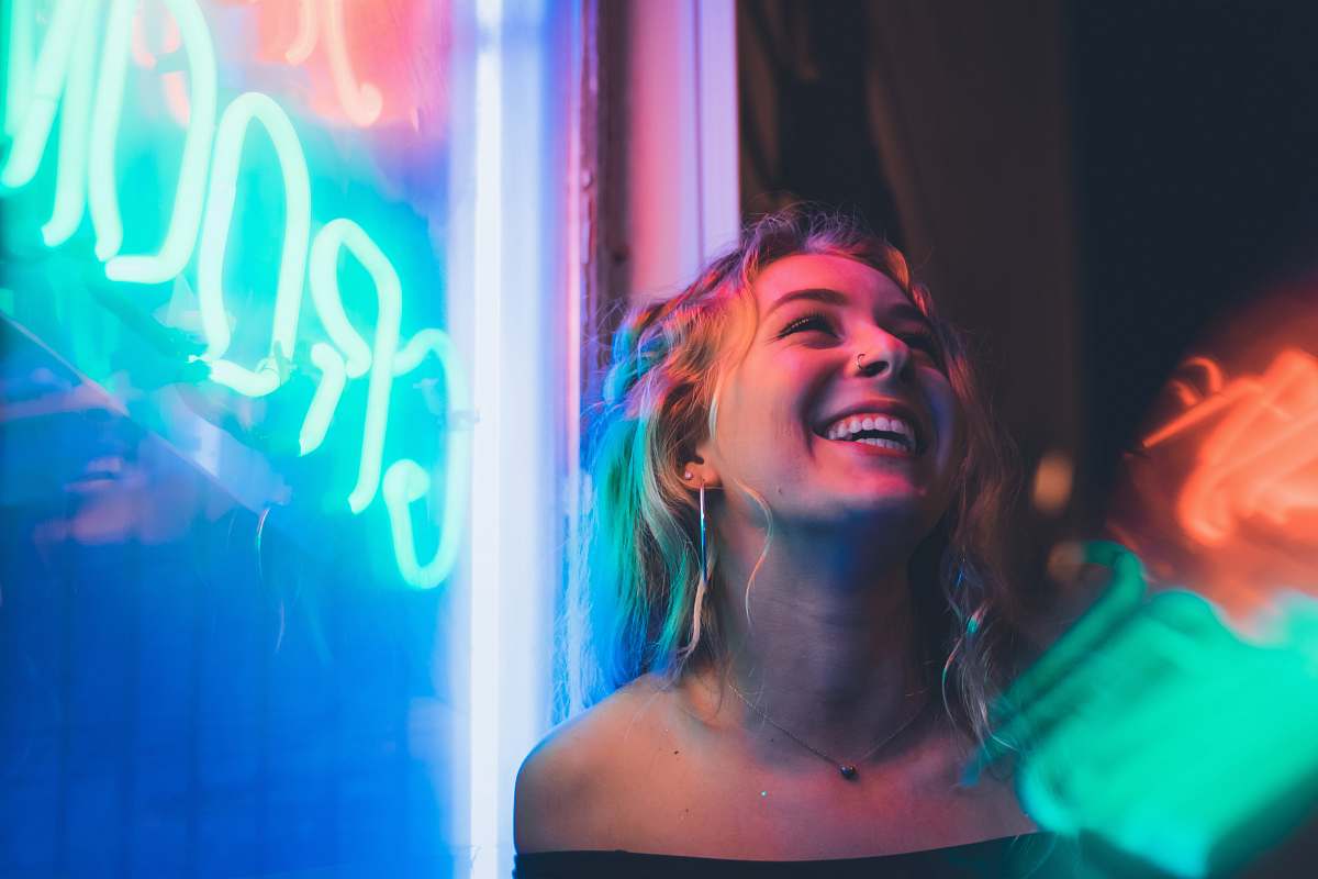 human woman standing beside neon light club