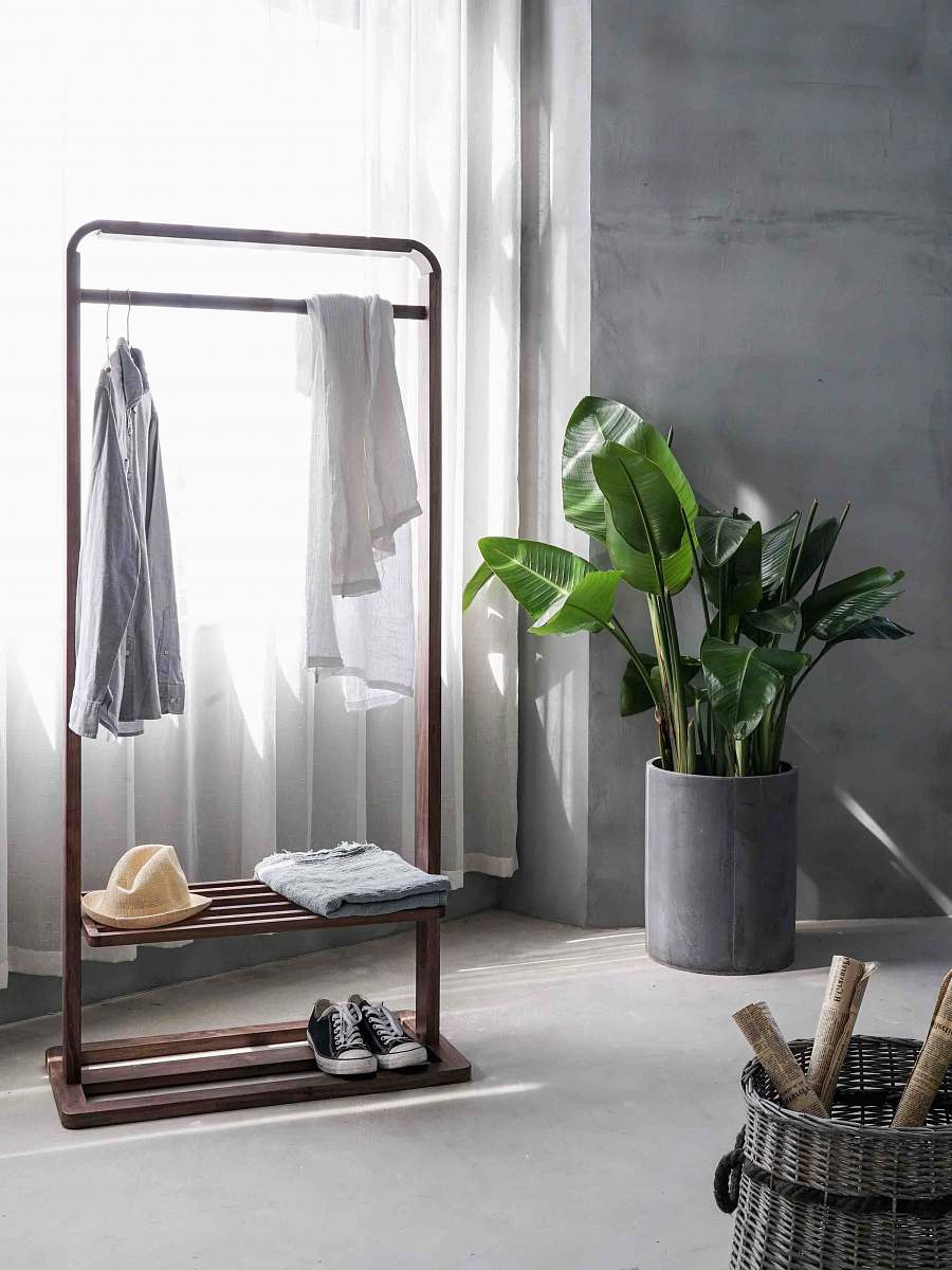 interior gray dress shirt hang on brown wooden rack in front of window with white curtain home