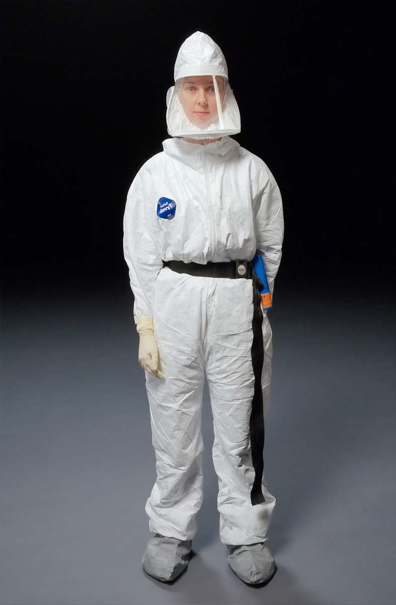medical person wearing white overalls air purifying respirator