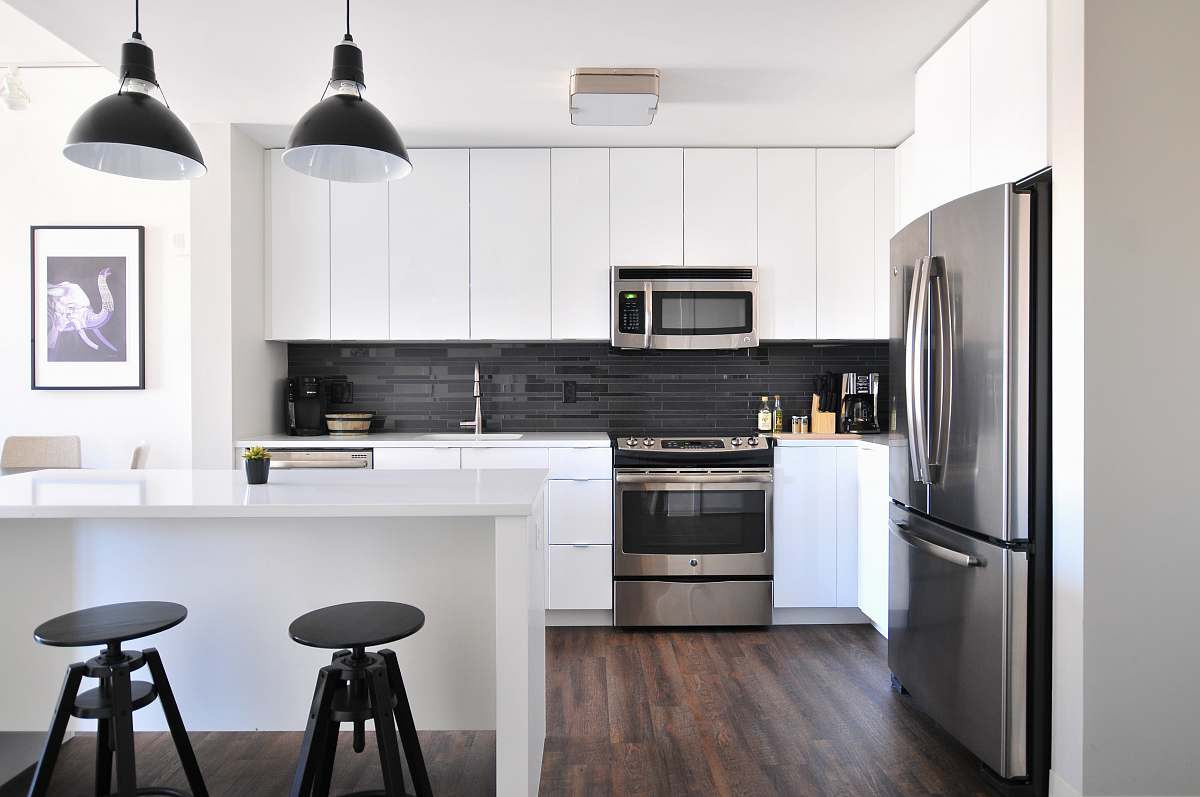 kitchen gray steel 3-door refrigerator near modular kitchen interior