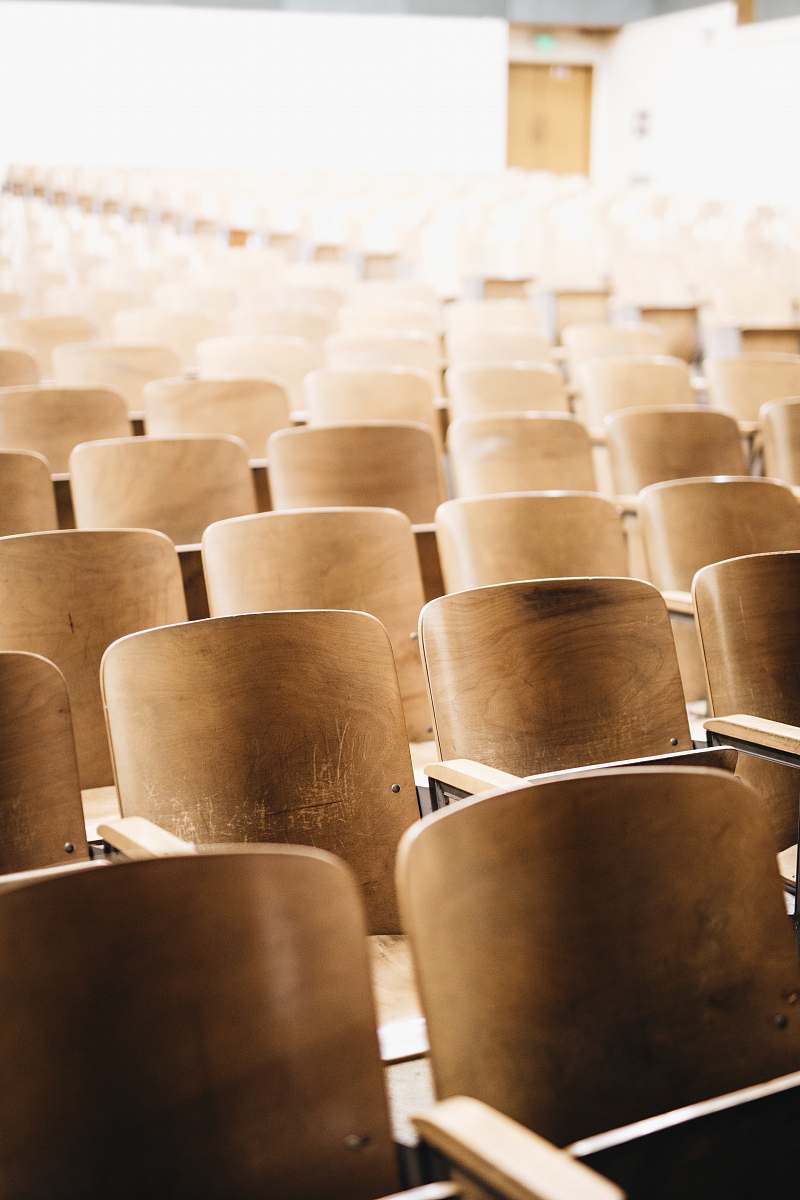 hall vacant brown wooden chair at stadium indoors