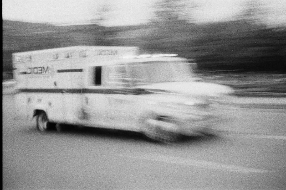 grey medic van on road black-and-white