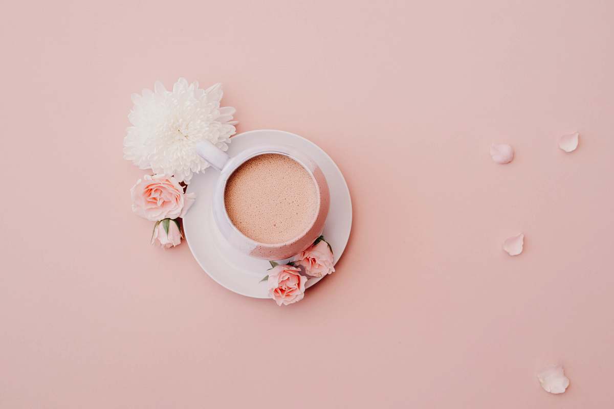 pink white glazed cup with saucer on pink surface pastel