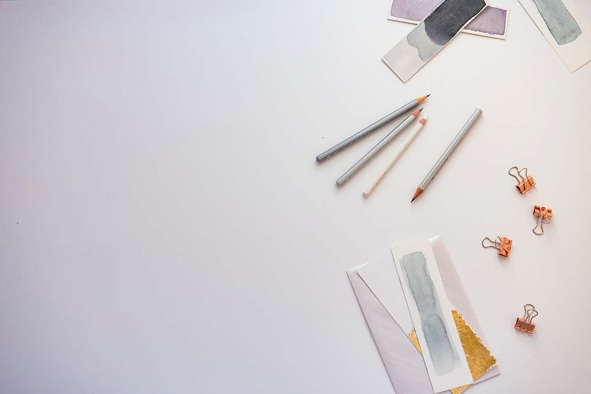 background high angle photo of four pencils and greeting card grey