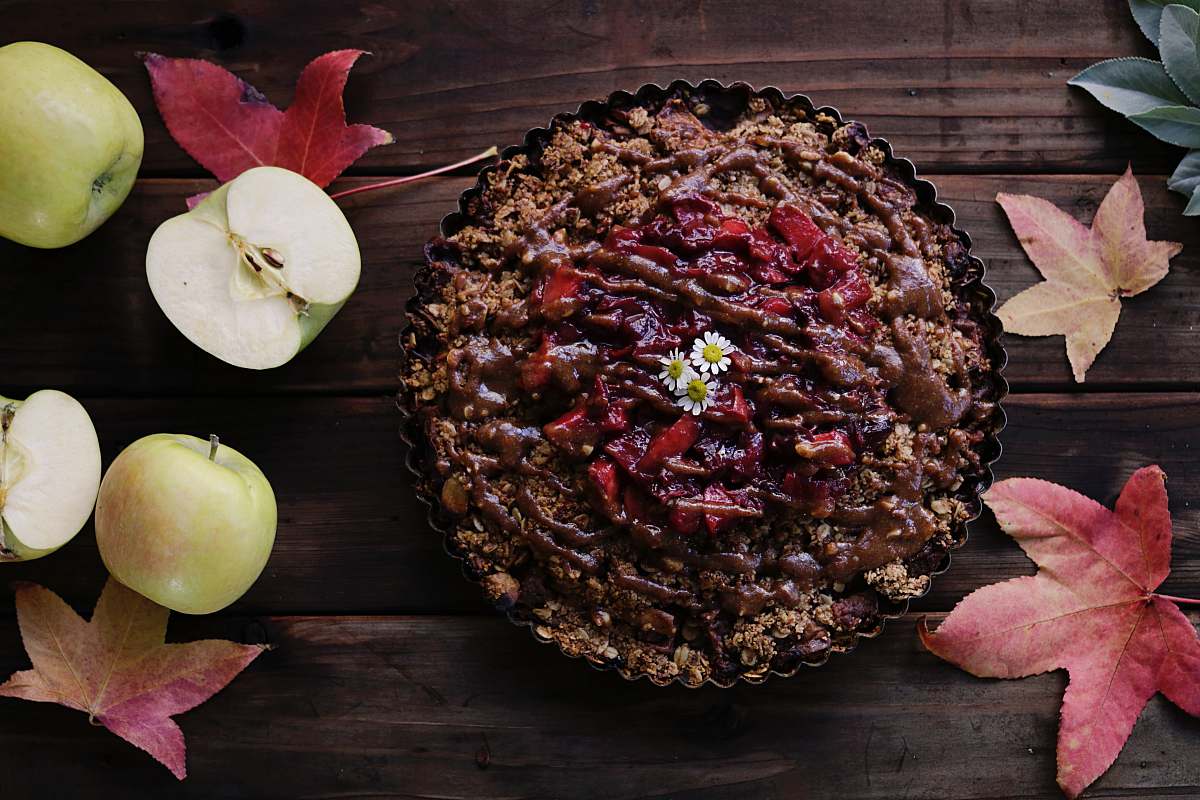 leaf baked pastry on brown wooden surface beside sliced apples cake