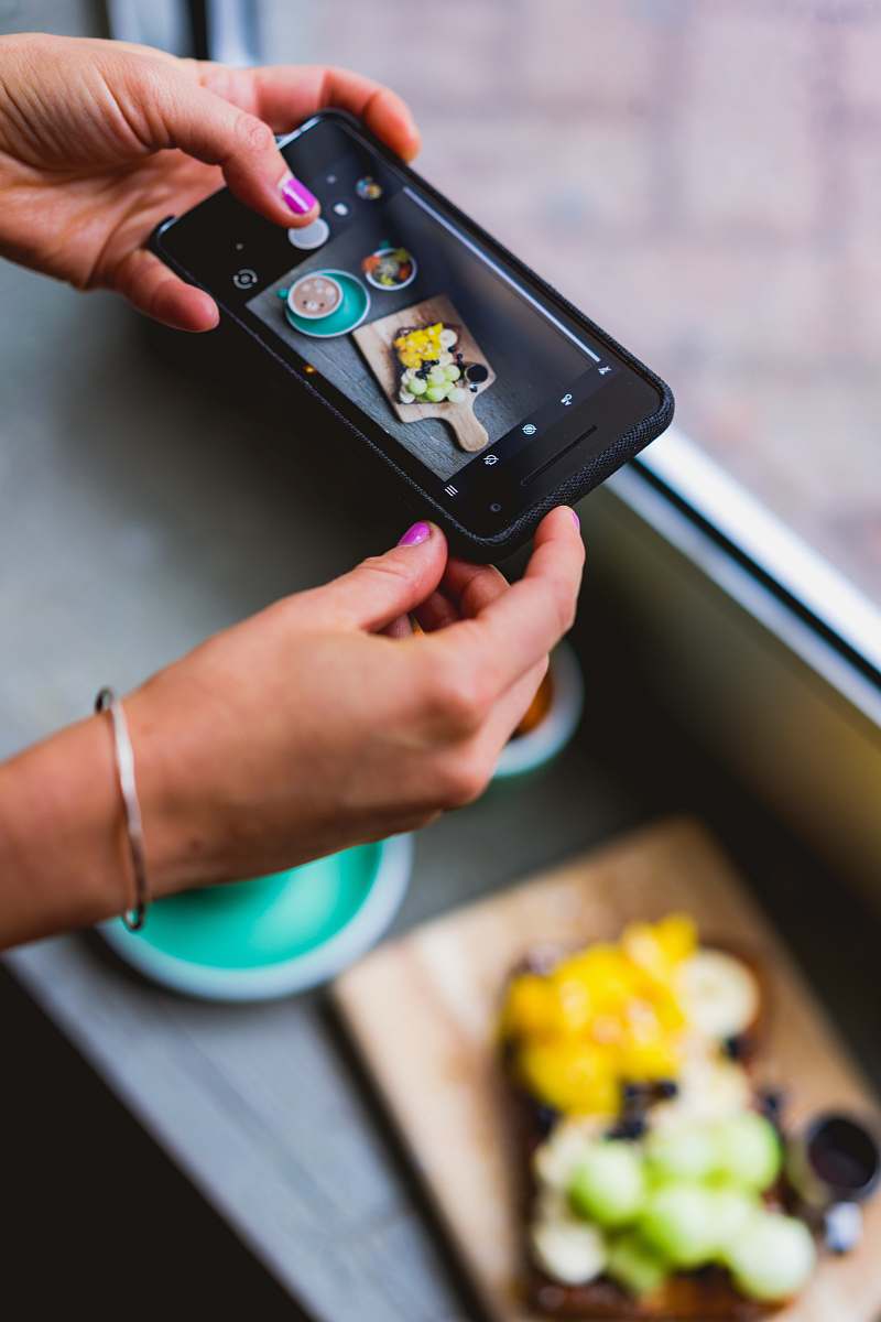 phone person taking photo of food cell phone