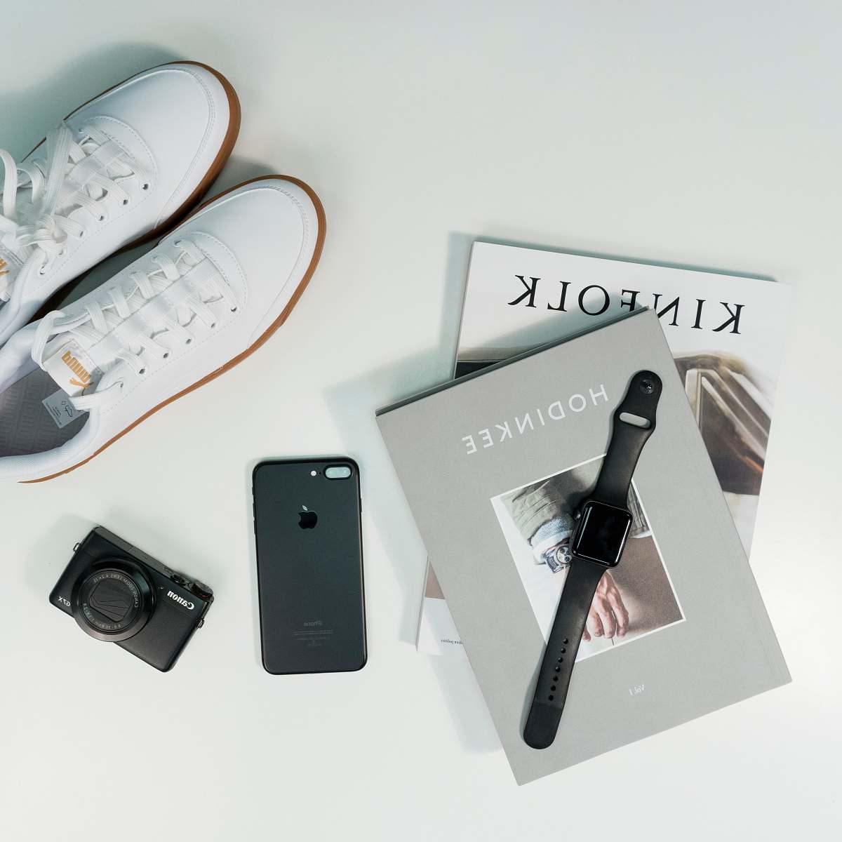 camera pair of white low-top shoes electronics