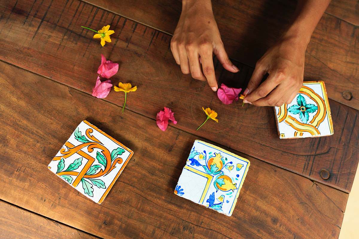 gambling person holding pink flower petal on brown parquet floor game