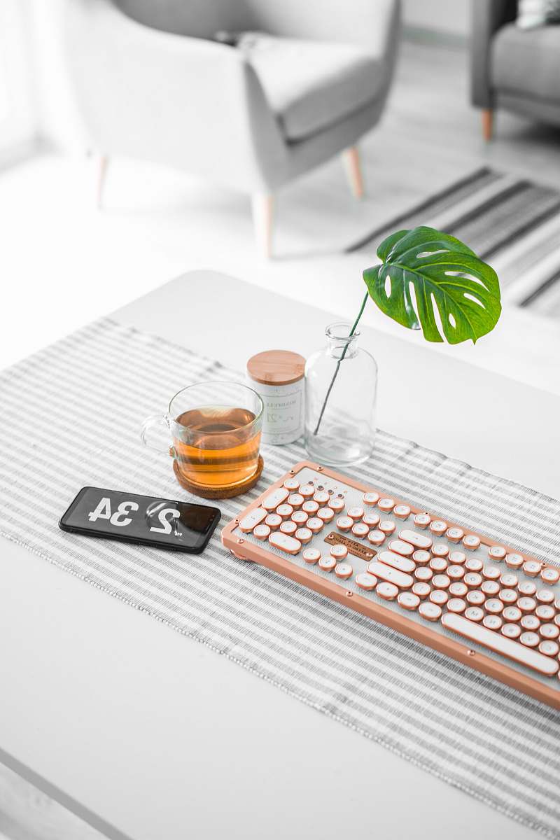 chair brown computer keyboard beside glass mug furniture