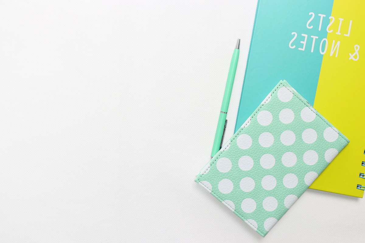 blue teal and white polka-dot wallet on table learning language