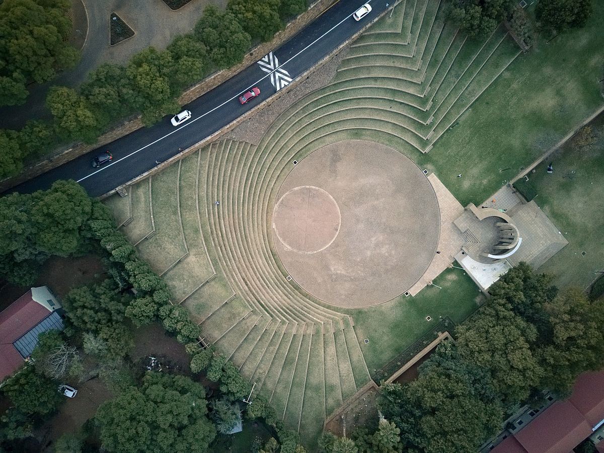 aerial photo of cars in highway passing park