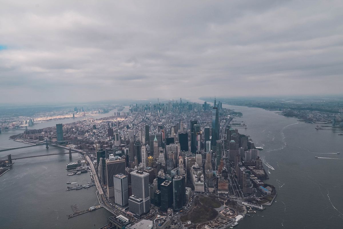 aerial photo of high rise buildings surrounded by sea during daytime