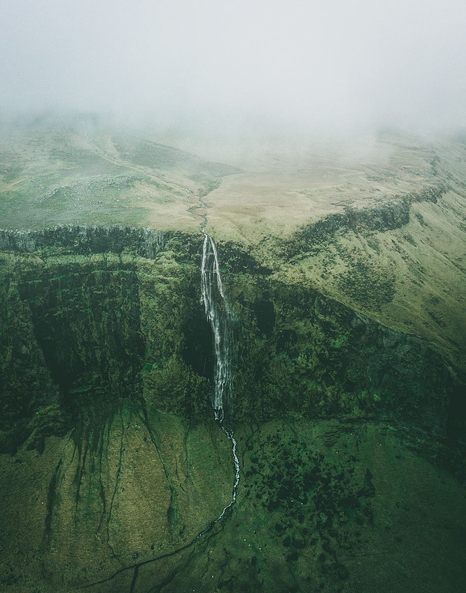 aerial photo of waterfalls during foggy weather