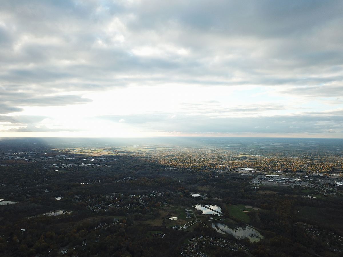 aerial photography of field under white and gray skies
