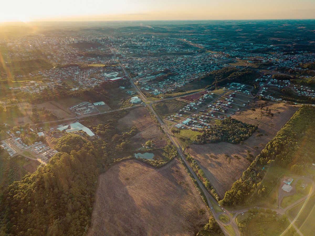 aerial view of houses and trees during sunrise