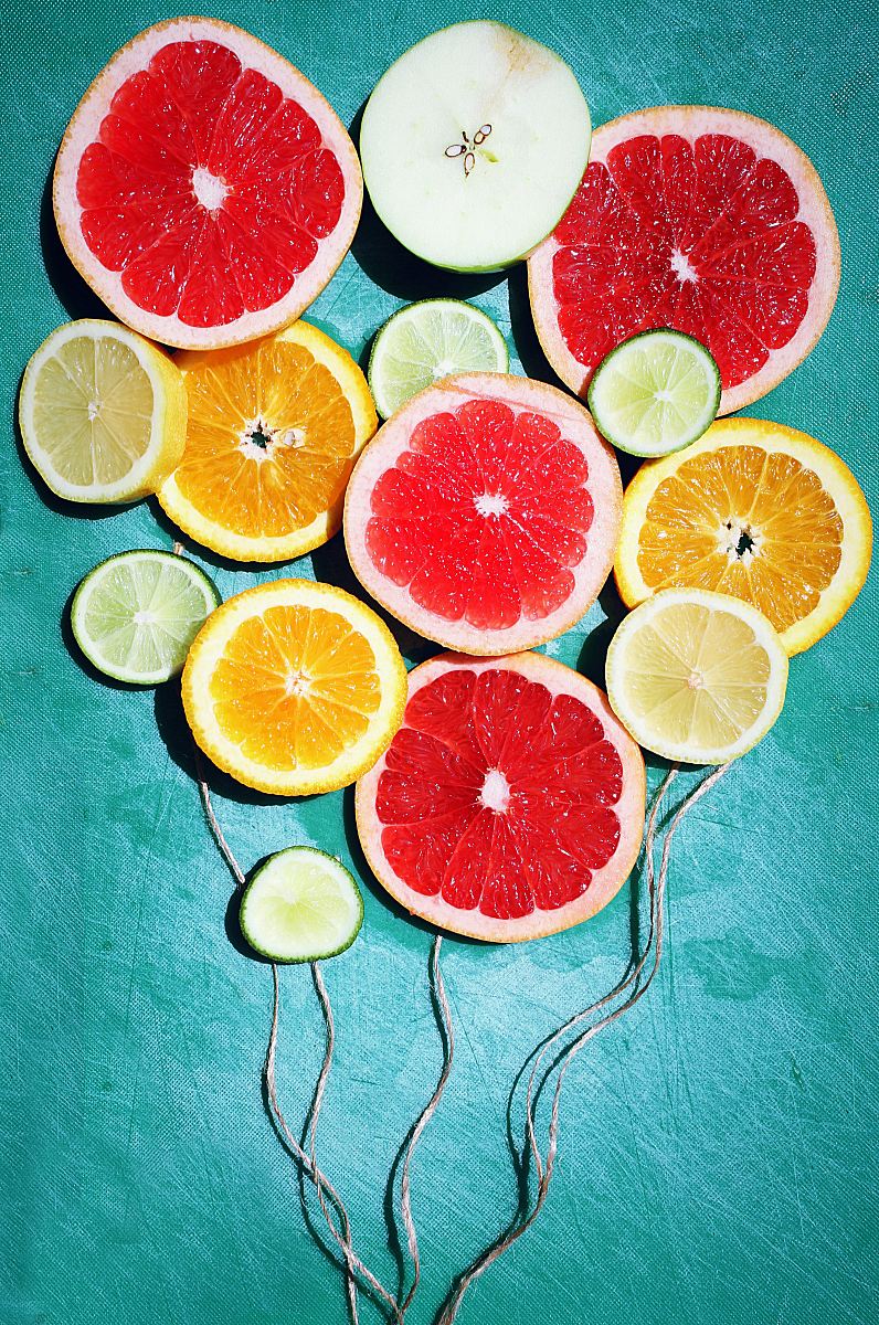 assorted fruit slices decor on teal surface