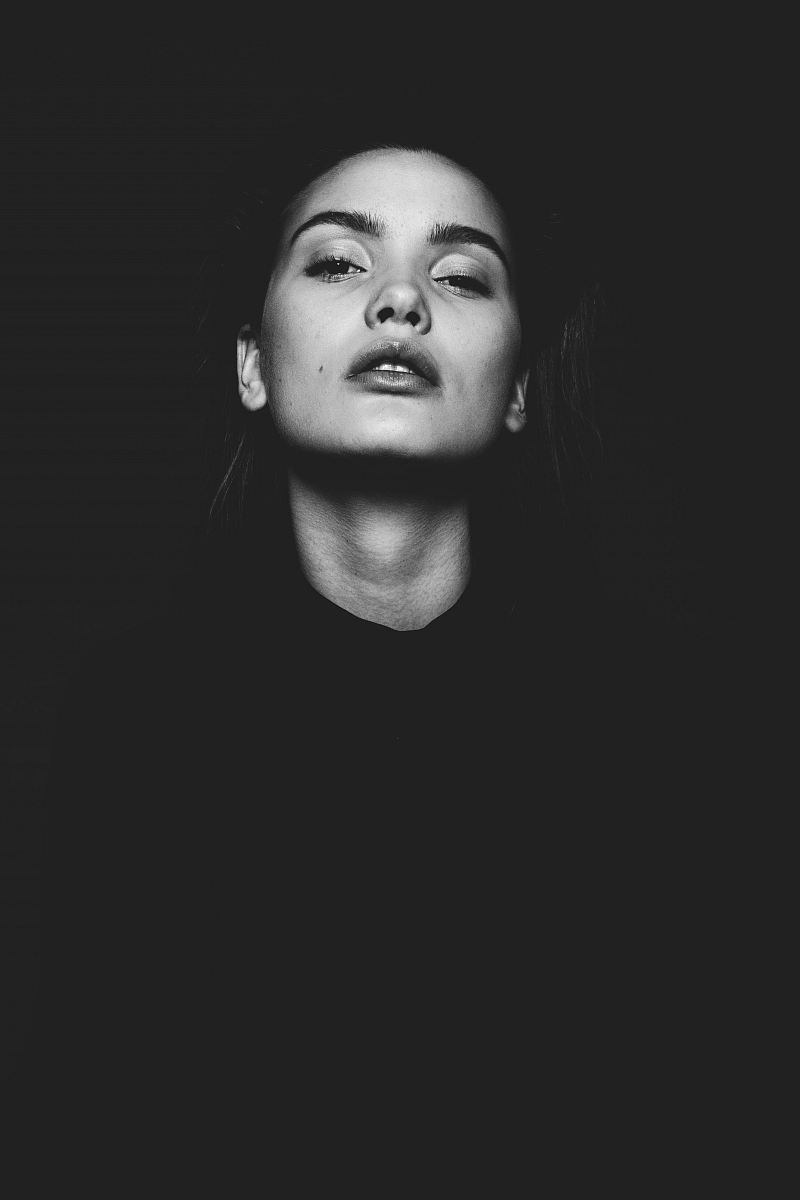 black and white photo of woman looking upward