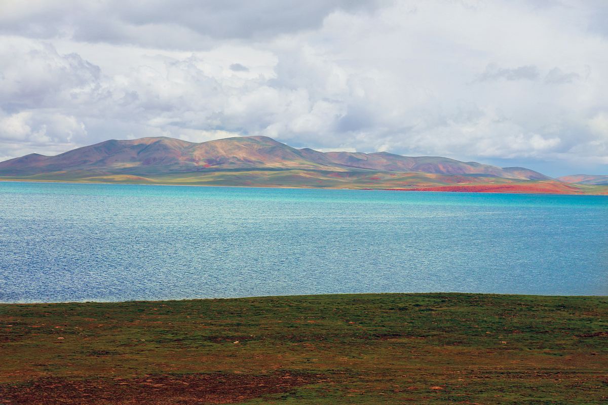 body of water and brown mountain range