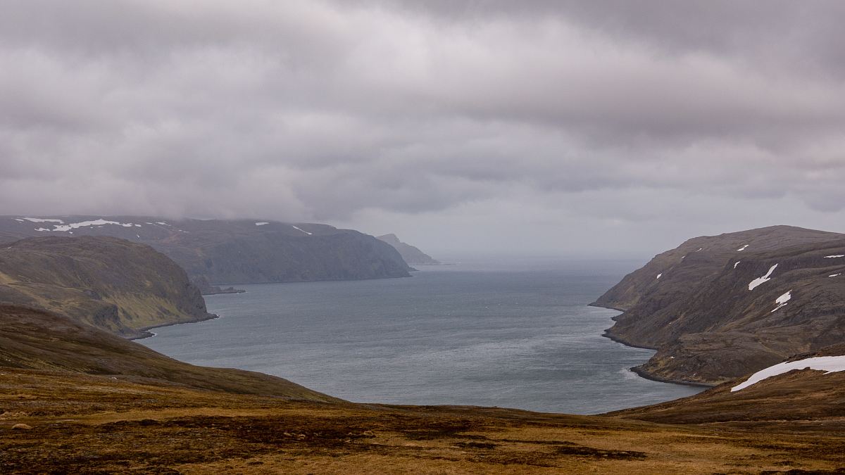body of water under cloudy sky