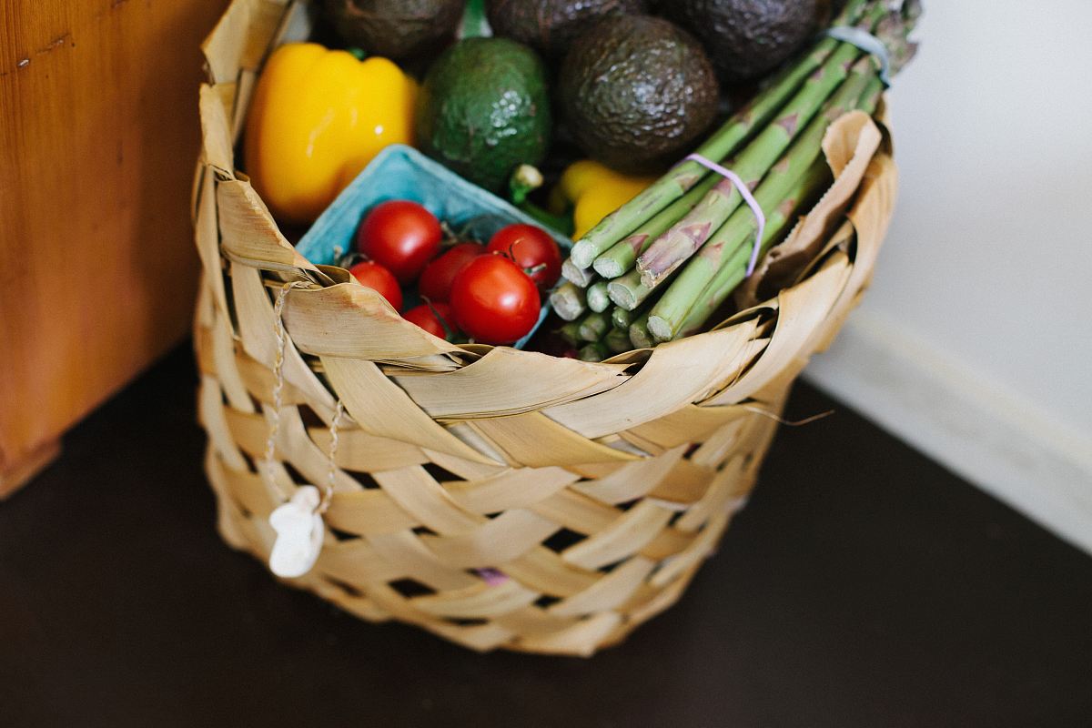 bunch of assorted produce in brown wicker basket