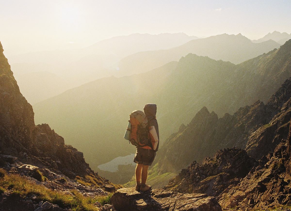 Climber Standing On Rock Near Overlooking View Of Mountain At Daytime ...