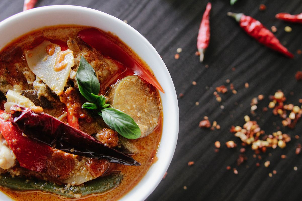 flat-lay photography of vegetable soup on white ceramic cup